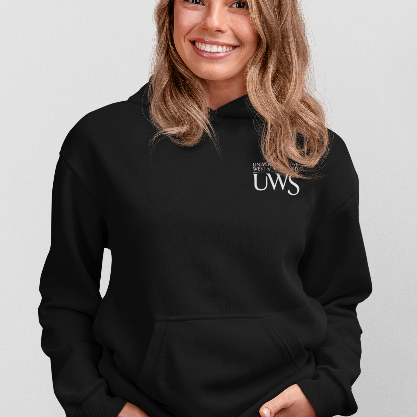 Woman wearing a black hoodie with 'UWS' text on a light gray background